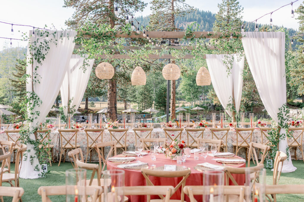 beautiful and timeless wedding reception with wooden chairs and ivy covered linens