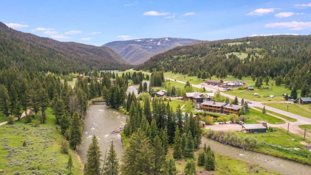 resort and wedding venue in a valley between mountains at Rainbow Ranch Lodge in Big Sky Montana
